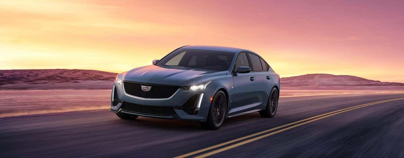 A grey 2024 Cadillac CT5 is shown driving to visit a Cadillac dealer near Milton.