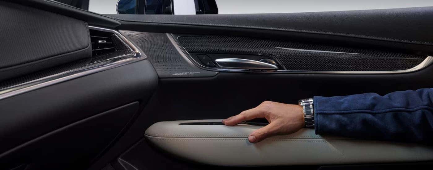 An arm resting on the armrest of a 2025 Cadillac XT5.