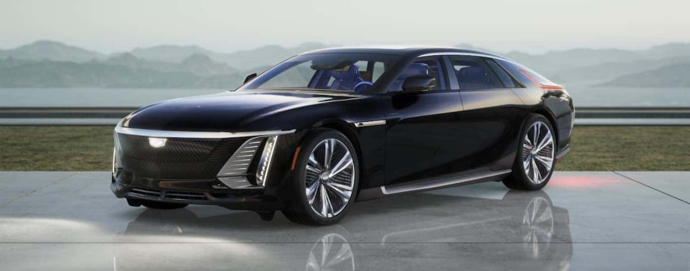 A black 2024 Cadillac CELESTIQ is shown parked near a Marietta Cadillac dealer.