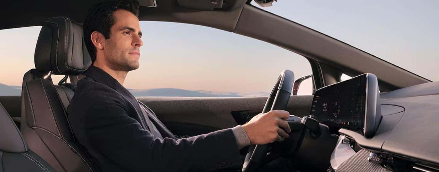 A person driving in a 2026 Cadillac OPTIQ-V.