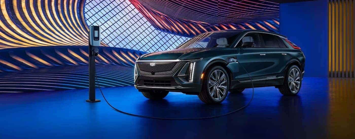 Blue 2025 Cadillac LYRIQ parked in a showroom.