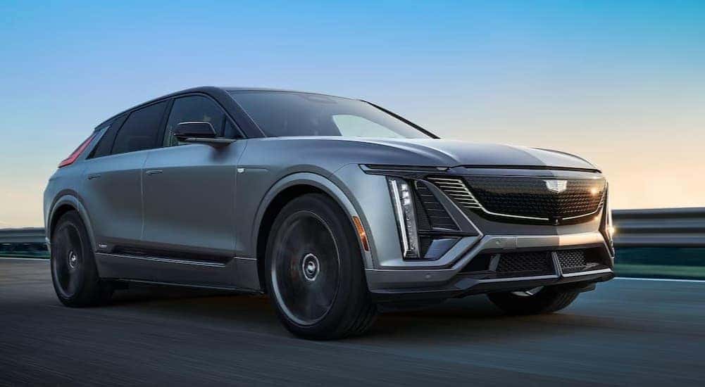 A silver 2026 Cadillac LYRIQ driving on a highway.