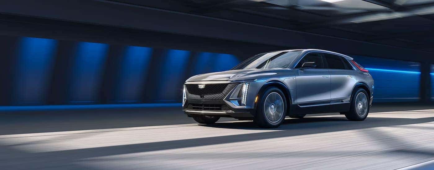 A silver 2026 Cadillac LYRIQ driving down a highway