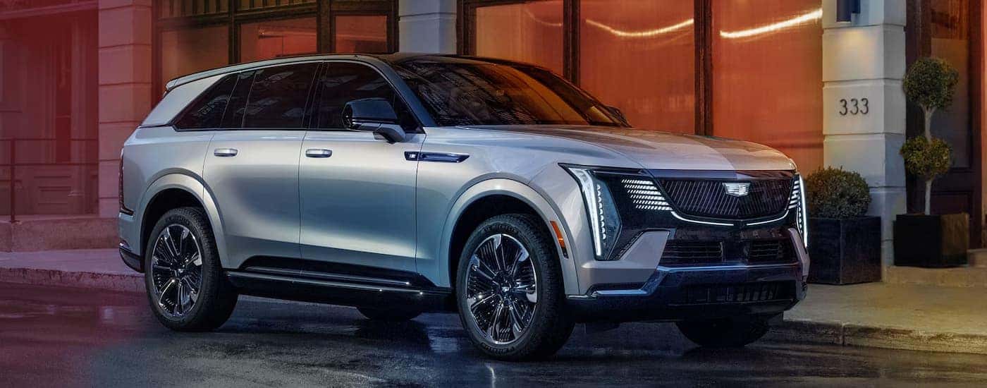 A silver 2026 Cadillac Escalade IQ parked in a city