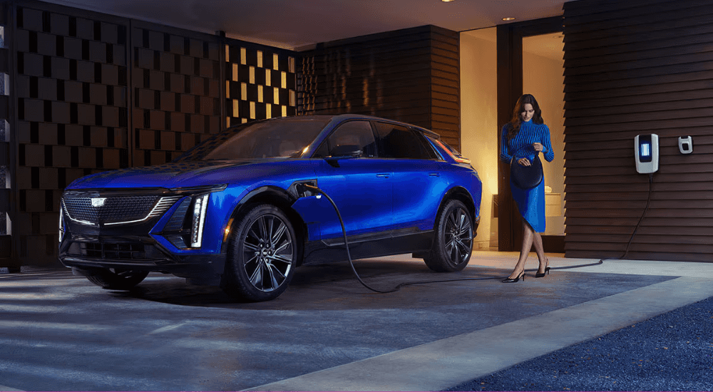 A person approached their blue 2026 Cadillac LYRIQ while charging