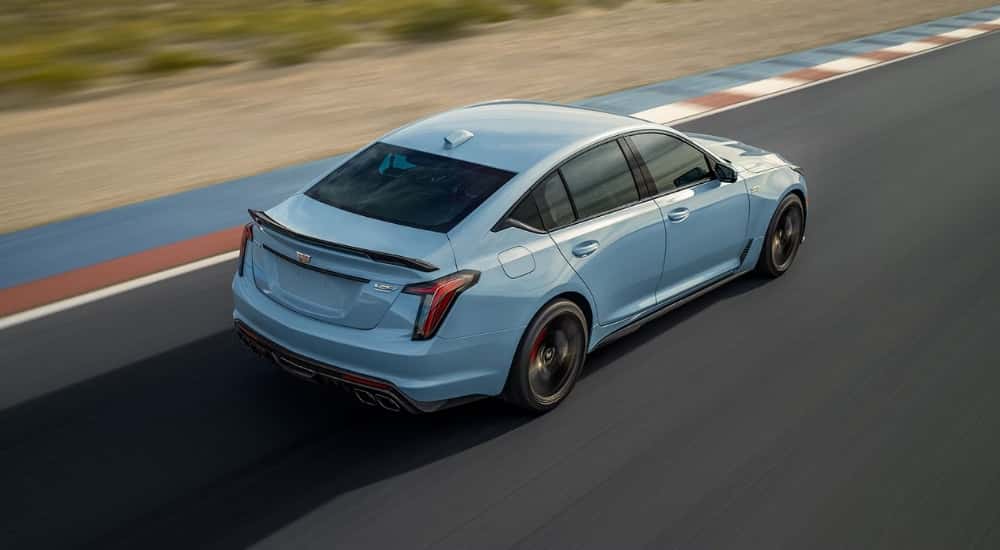 Blue 2026 Cadillac CT5-V driving on a racetrack