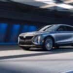 A silver 2026 Cadillac LYRIQ driving in a city.