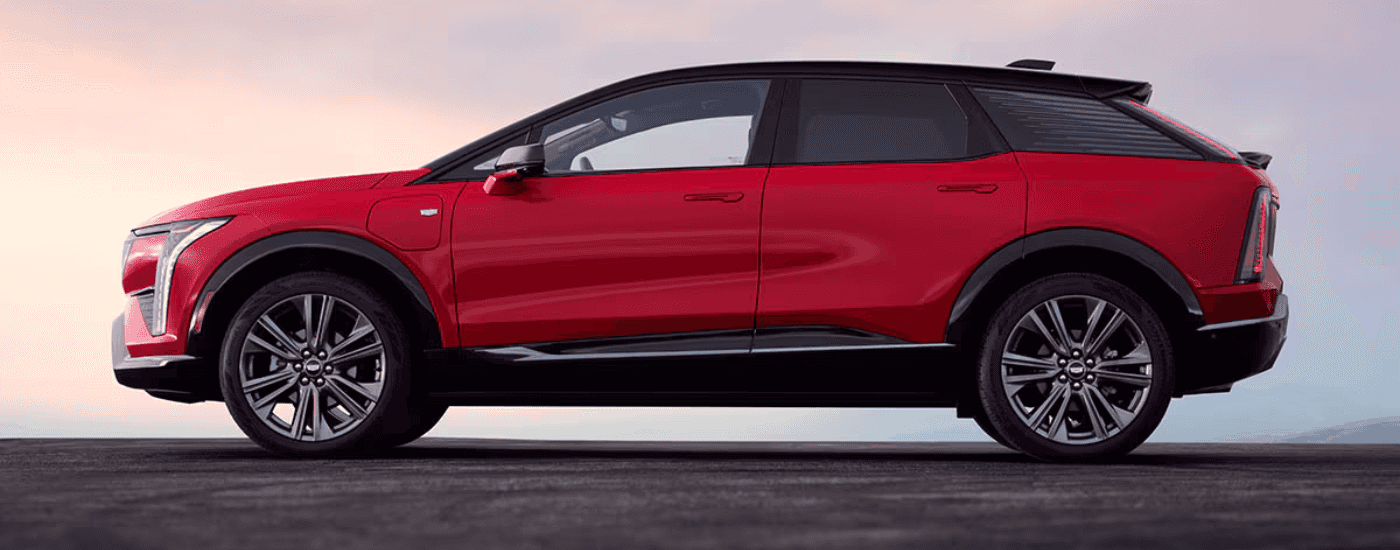 Side profile of a red 2026 Cadillac OPTIQ for sale in Atlanta