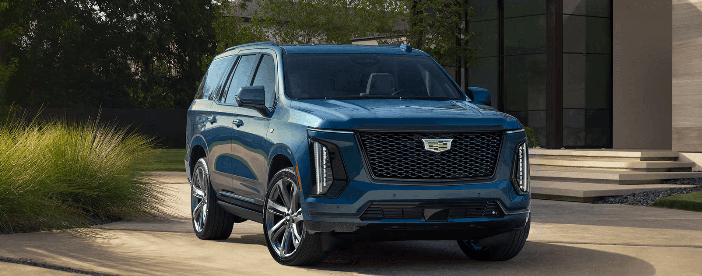 Blue 2026 Cadillac Escalade parked in front of a house