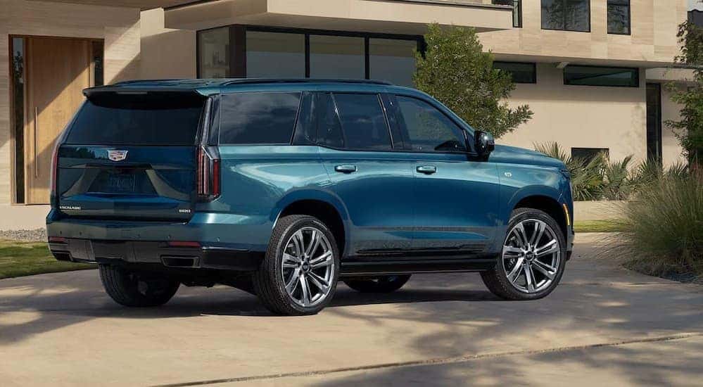 A blue 2026 Cadillac Escalade parked on a driveway.