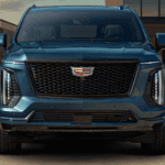 Blue 2026 Cadillac Escalade parked in front of a house head on