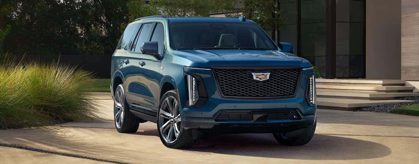 A blue 2026 Cadillac Escalade parked in a driveway