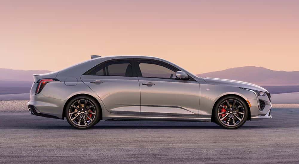 Silver 2026 Cadillac CT4 side view at sunset