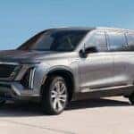 Silver 2026 Cadillac VISTIQ parked in a waterfront driveway