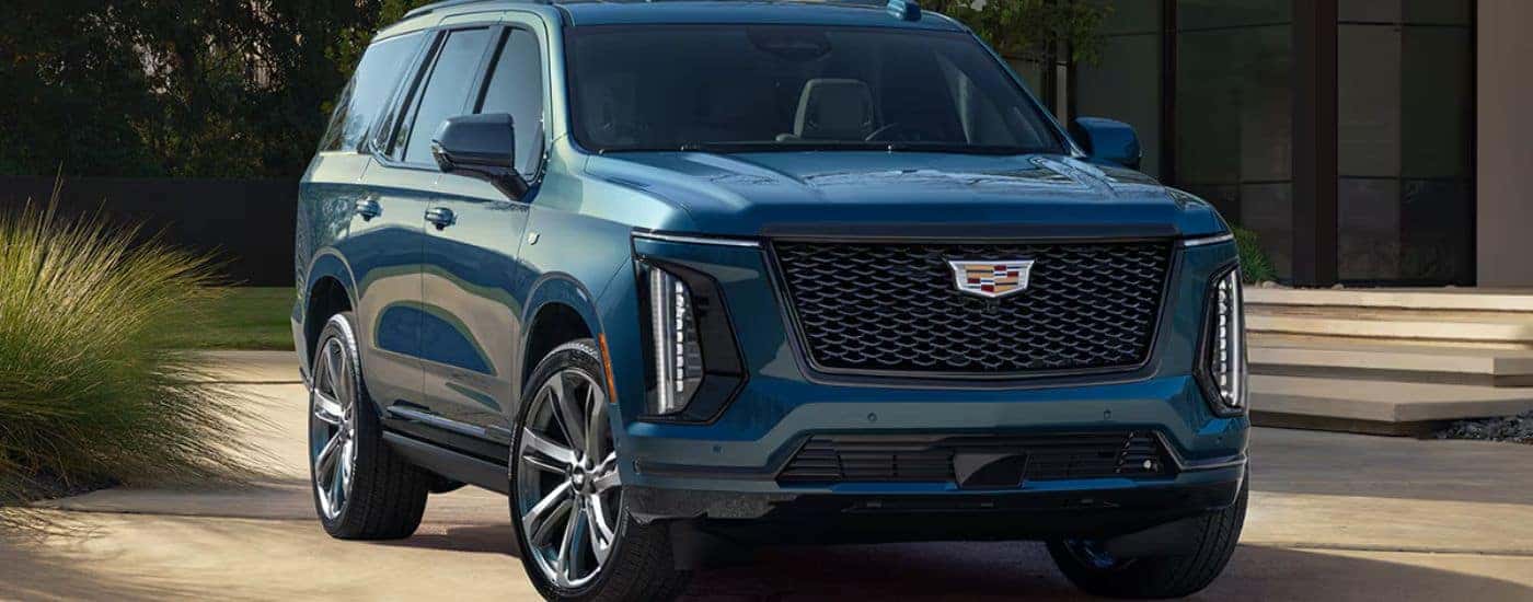 Blue 2026 Cadillac Escalade parked in a driveway.
