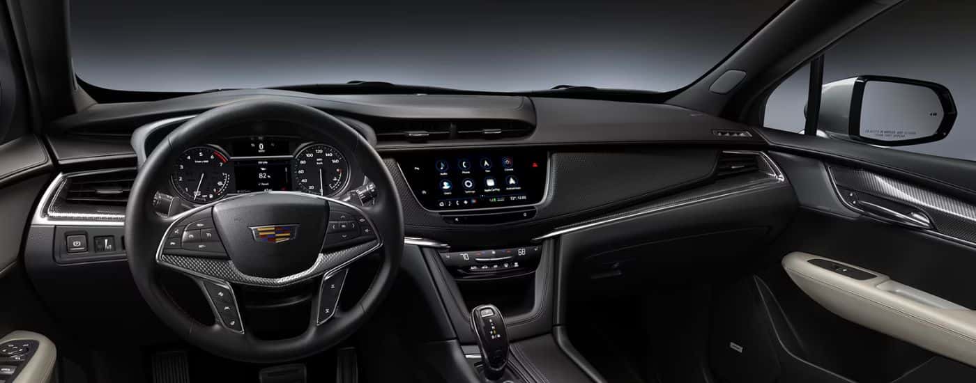 Interior view of a 2026 Cadillac XT5 infotainment display, gauge cluster and steering wheel.
