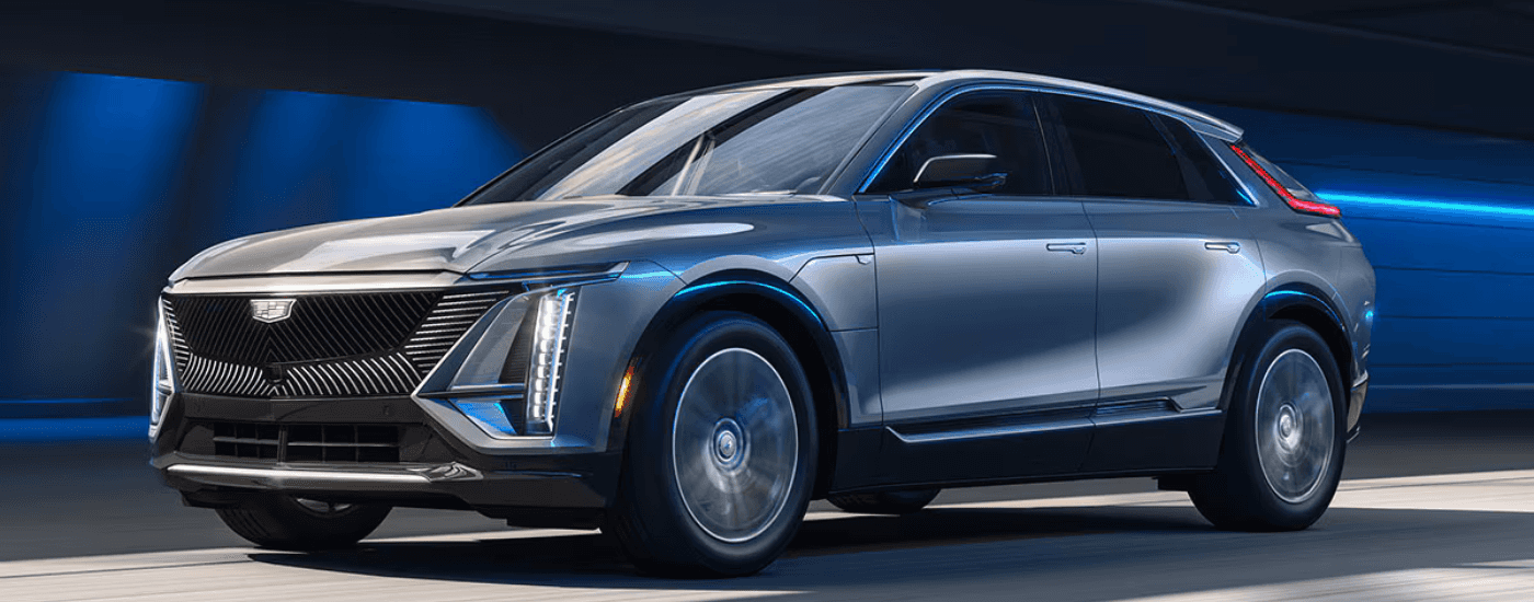 Silver 2026 Cadillac Lyriq driving through a city