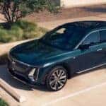 Teal 2026 Cadillac LYRIQ parked in a parking spot with charger.