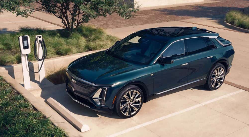 Teal 2026 Cadillac LYRIQ parked in a parking spot with charger.