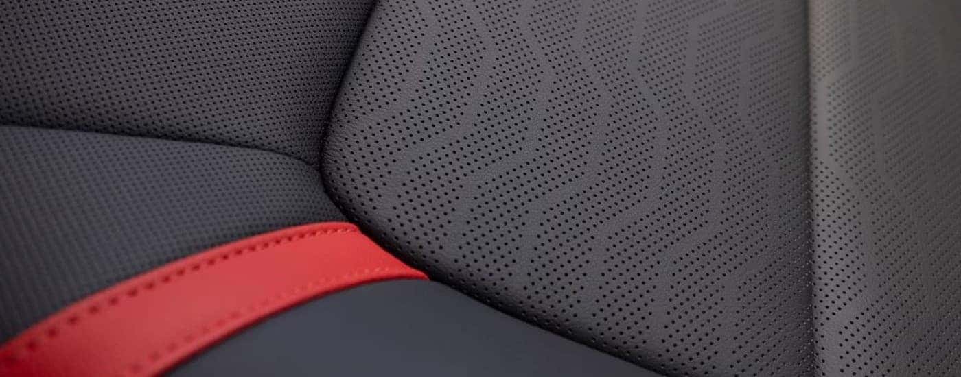 A close up shows the red accents on a black seat in a 2023 Chevy Colorado.
