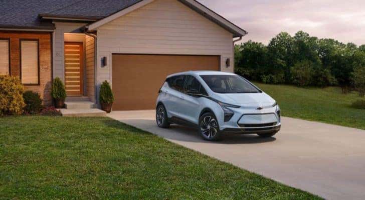 A light blue 2023 Chevy Bolt EV is shown parked on a driveway after leaving a Chevrolet dealer near Atlanta, GA.