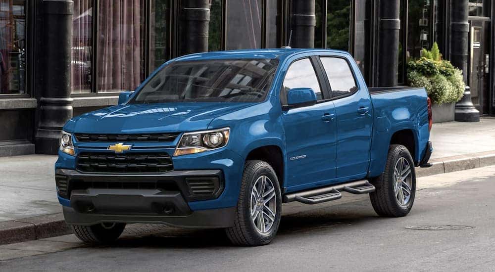 A blue 2022 Chevy Colorado is shown parked on a city street.