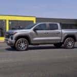A silver 2023 Chevy Colorado Z71 is shown driving on a city street after visiting Chevrolet dealer near Atlanta, GA.