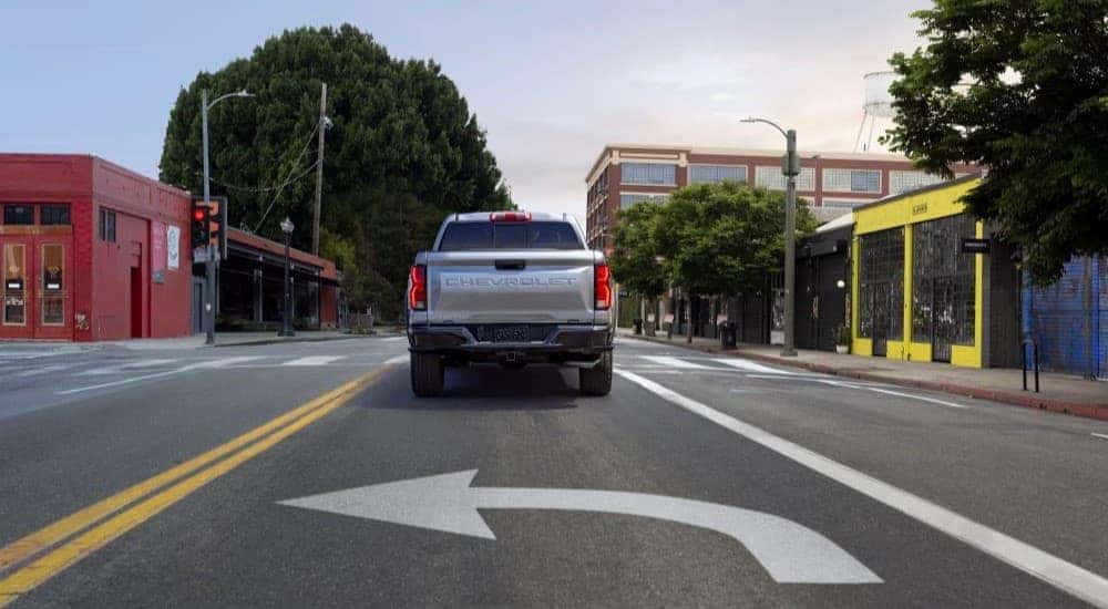 A silver 2023 Chevy Colorado Z71 is shown making a turn at an intersection.