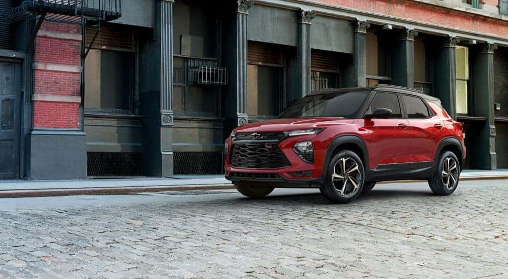 A red 2021 Chevy Trailblazer RS is shown parked on a paver street after leaving a used Chevy dealer in Chamblee, GA.