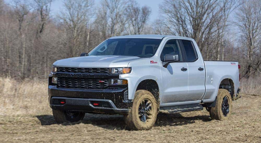 A grey 2023 Chevy Silverado 1500 Trail Boss is shown from the front at an angle after leaving a Chevy dealer near Brookhaven, GA.