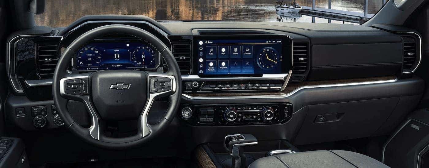A close up of the steering wheel and center console of a 2024 Chevy Silverado 1500 is shown.