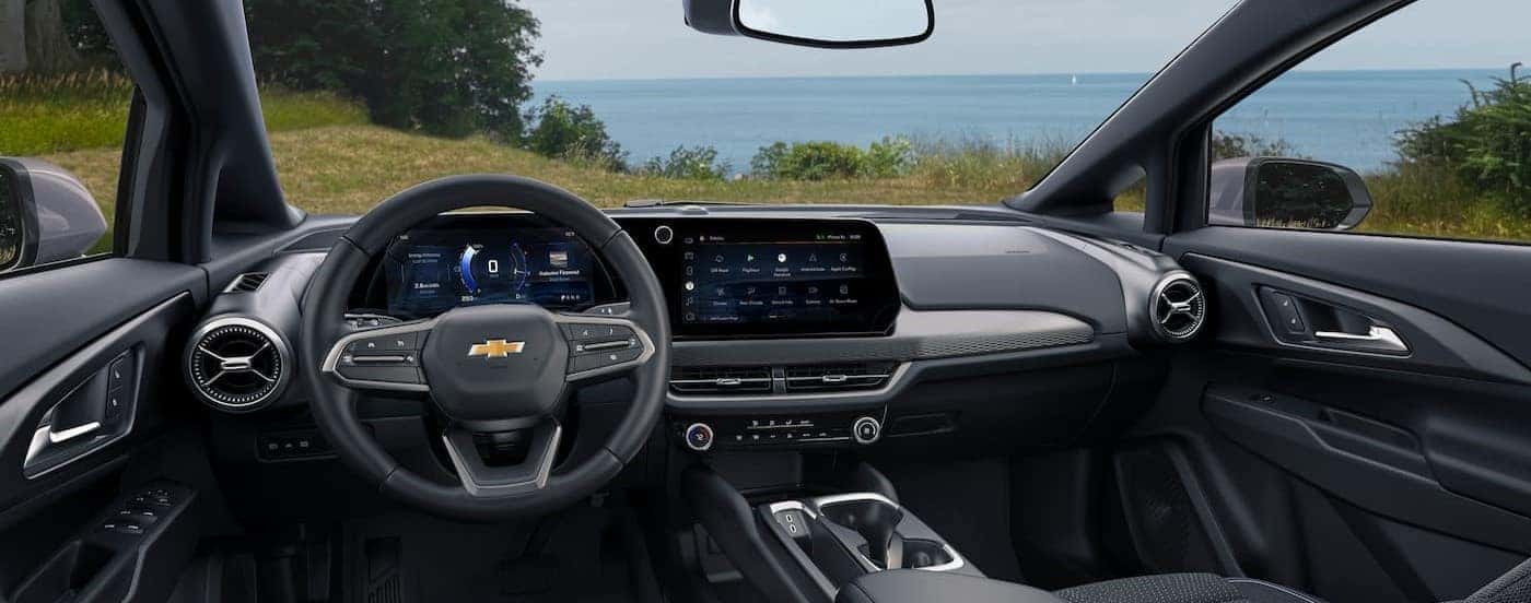 The black interior and dash of a 2024 Chevy Equinox EV is shown.
