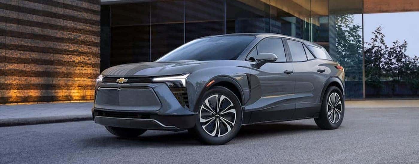 A gray 2024 Chevy Blazer EV is shown parked near a building.