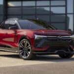 A red 2024 Chevy Blazer EV is shown parked outside a building.