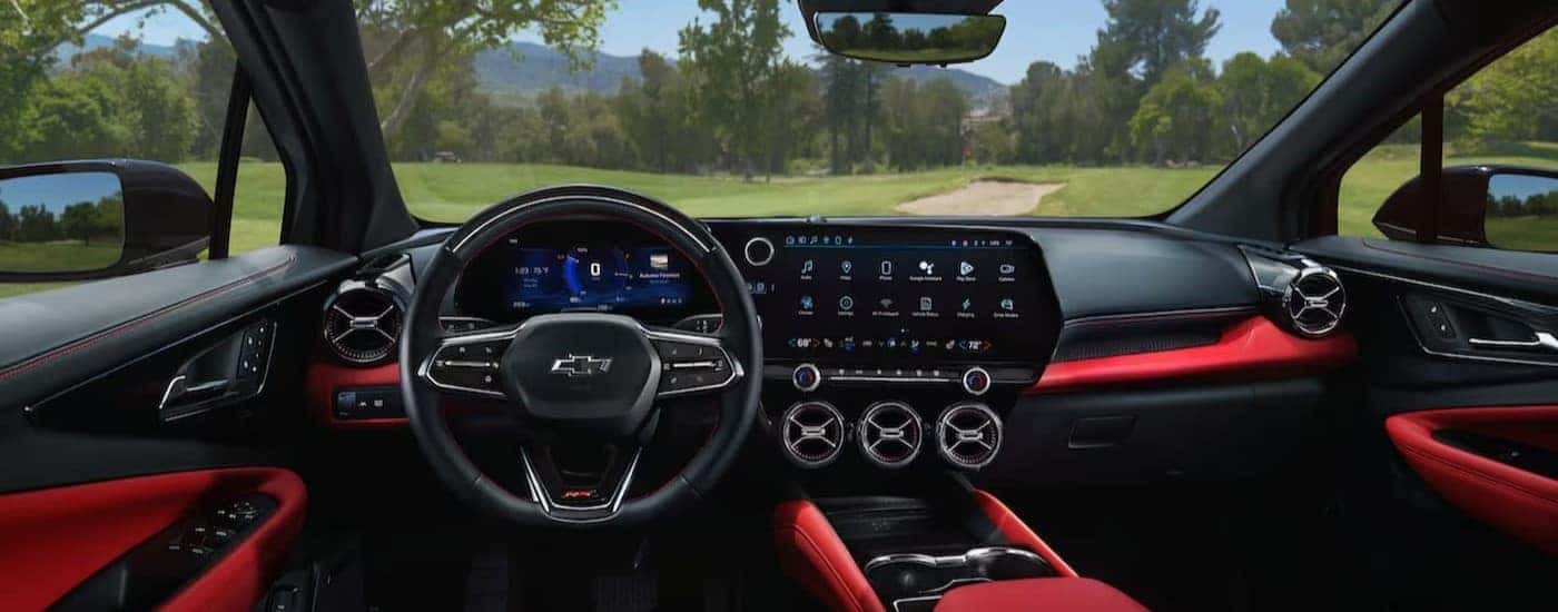 The black and red interior and dash of a 2024 Chevy Blazer EV is shown.
