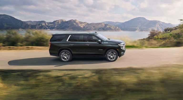 A green 2024 Chevy Tahoe High Country is shown from the side after leaving a Chevy dealer near Alpharetta..