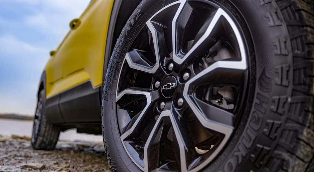A close-up to the rear wheel of a yellow 2024 Chevy Trailblazer ACTIV.