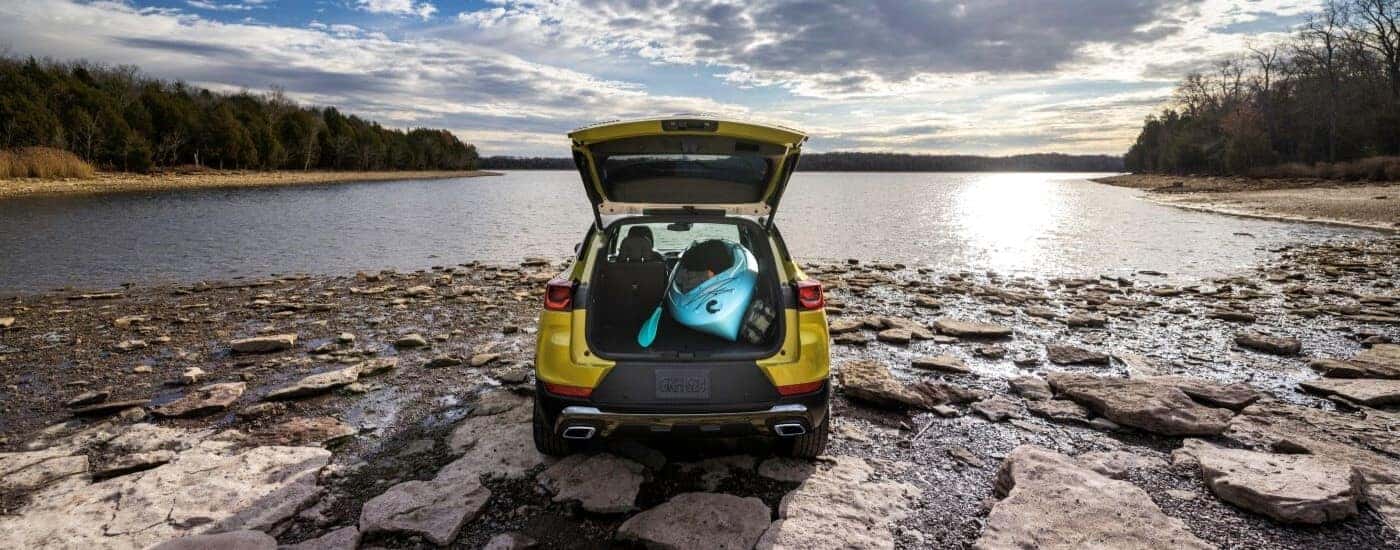A kayak is shown in the rear cargo area in a yellow 2024 Chevy Trailblazer ACTIV.