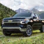A black 2024 Chevy Silverado 1500 for sale is shown from the front at an angle.