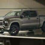 A silver 2024 Chevy Silverado 1500 Redline Edition is shown parked in a hangar.