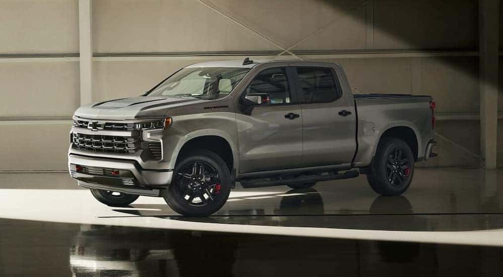 A silver 2024 Chevy Silverado 1500 Redline Edition is shown parked in a hangar.