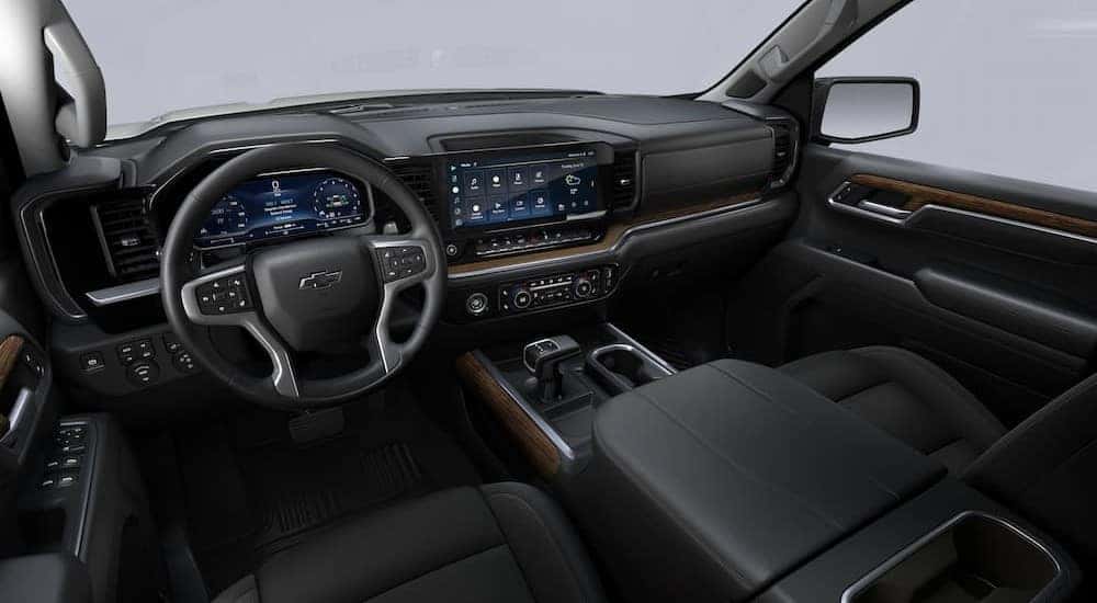 The black interior and dash in a 2024 Chevy Silverado 1500 RST is shown.
