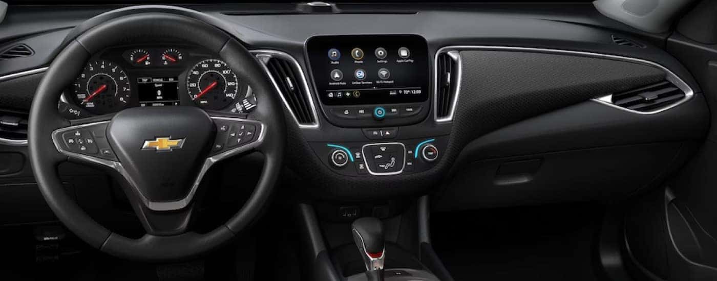 The steering wheel and infotainment screen in a 2025 Chevy Malibu RS.