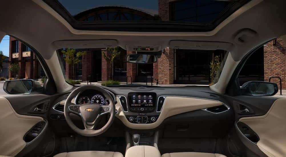The black and tan interior and dash in a 2025 Chevy Malibu is shown.