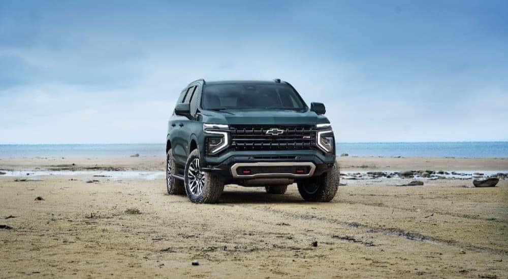 A green 2025 Chevy Tahoe Z71 is shown parked off-road.