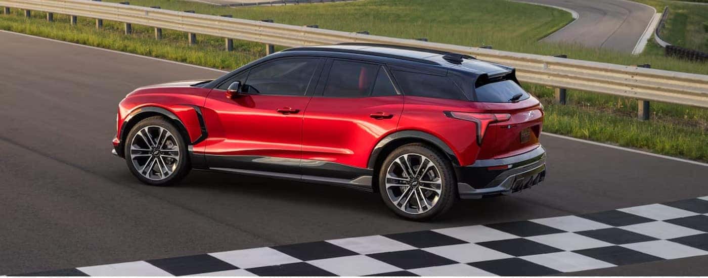 A red 2025 Chevy Blazer RS EV is shown parked near a finish line.