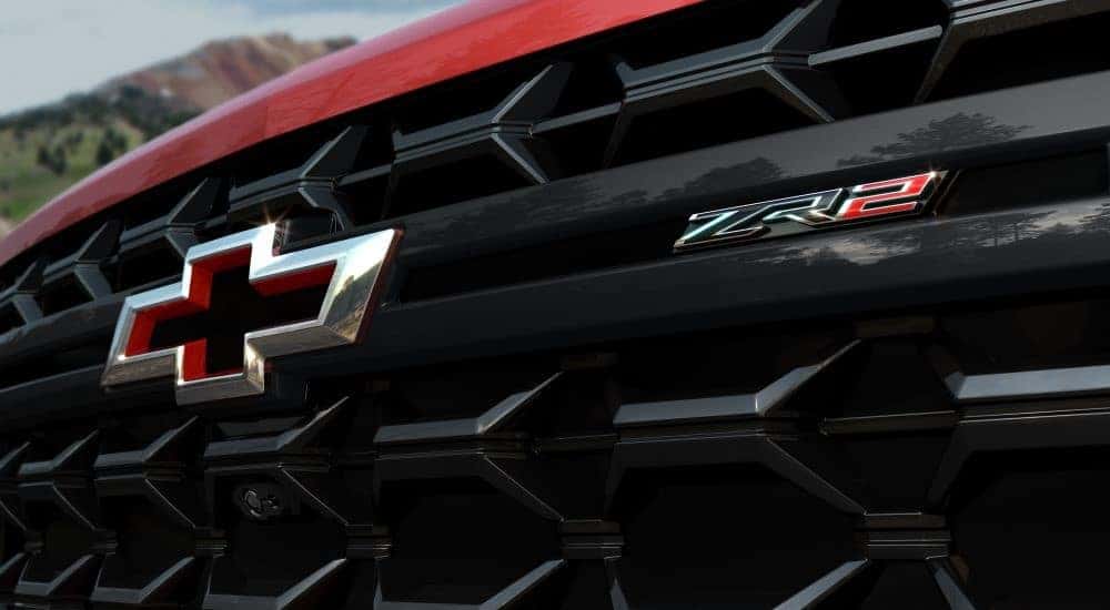 Close-up on the grille and hood of a red 2024 Chevy Silverado 2500 HD ZR2.