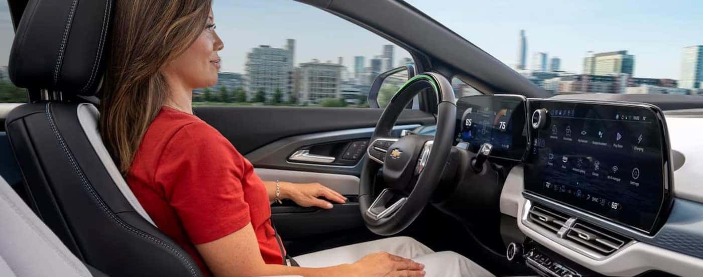 The black and white interior and dash are shown in a 2024 Chevy Equinox EV for sale.
