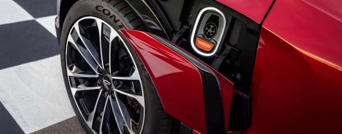 A close up shows the charging port on a red 2024 Chevy Blazer EV.