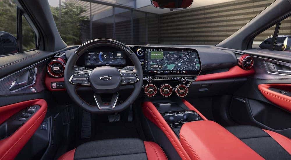 The red interior of a 2024 Chevy Blazer EV SS is shown from the driver's seat.